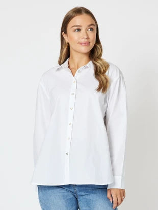 Women’s white button-down shirt with blue jeans casual outfit front view