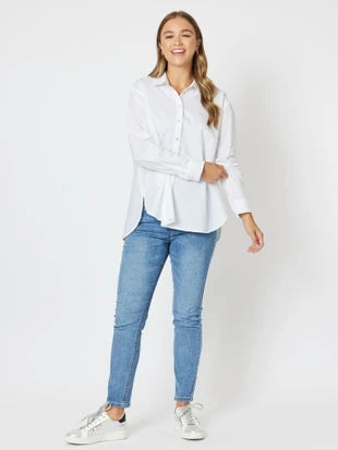 White long sleeve shirt styled with blue denim jeans casual look