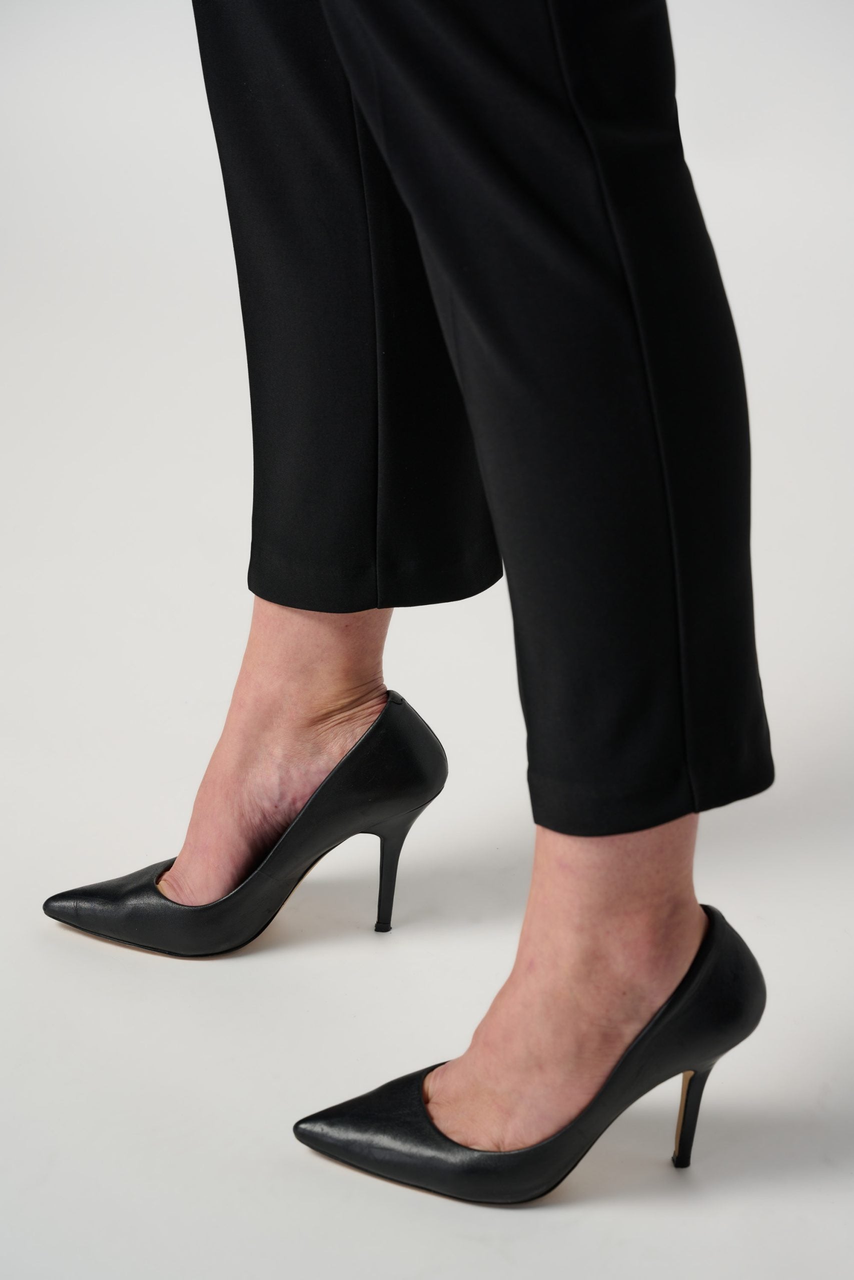 Black cropped pants with black heels close-up