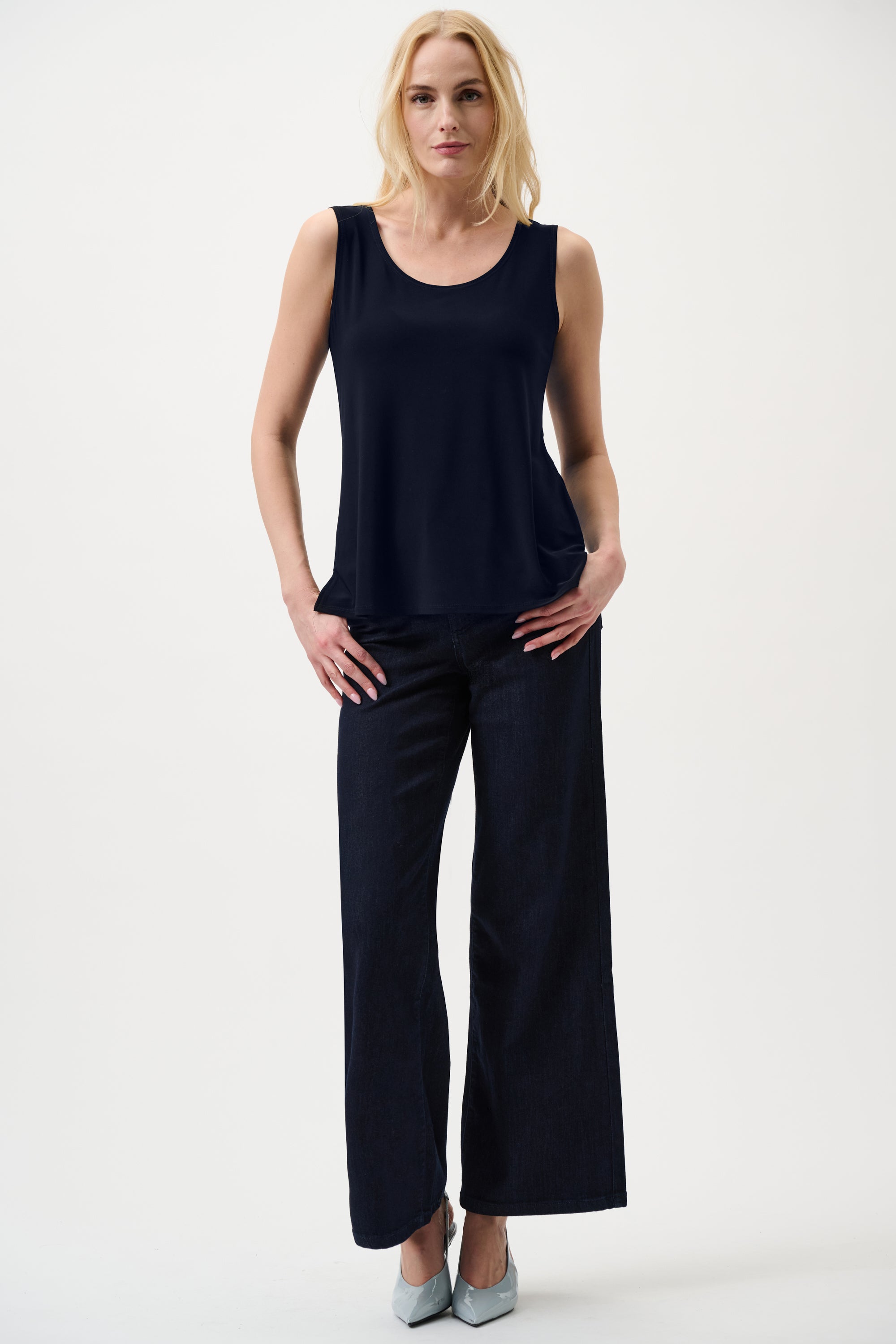 Women’s navy sleeveless tank top paired with dark wide leg pants smart casual outfit