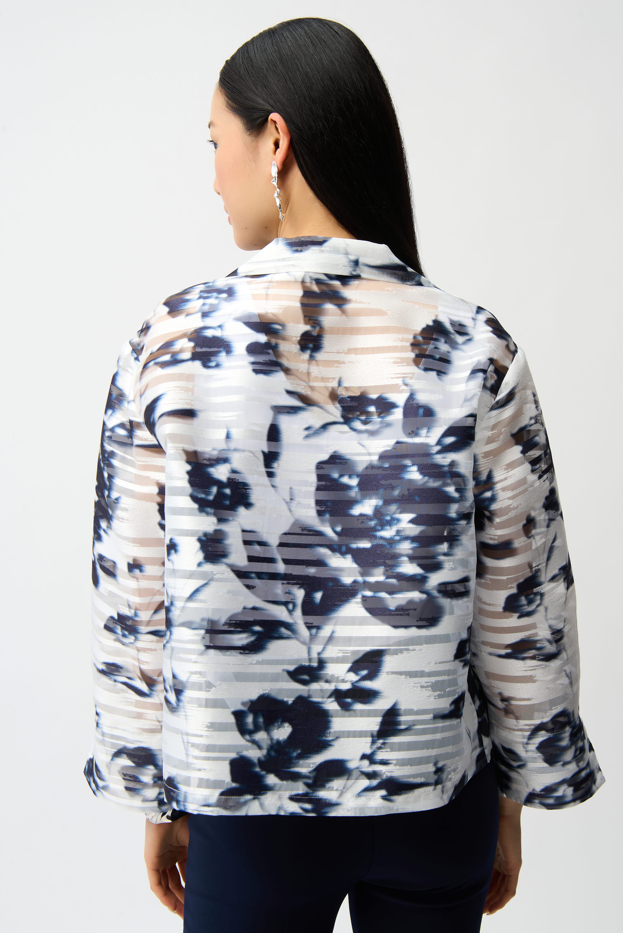 Back view of blue and white abstract print jacket with structured fit and three-quarter sleeves, studio shot on white background