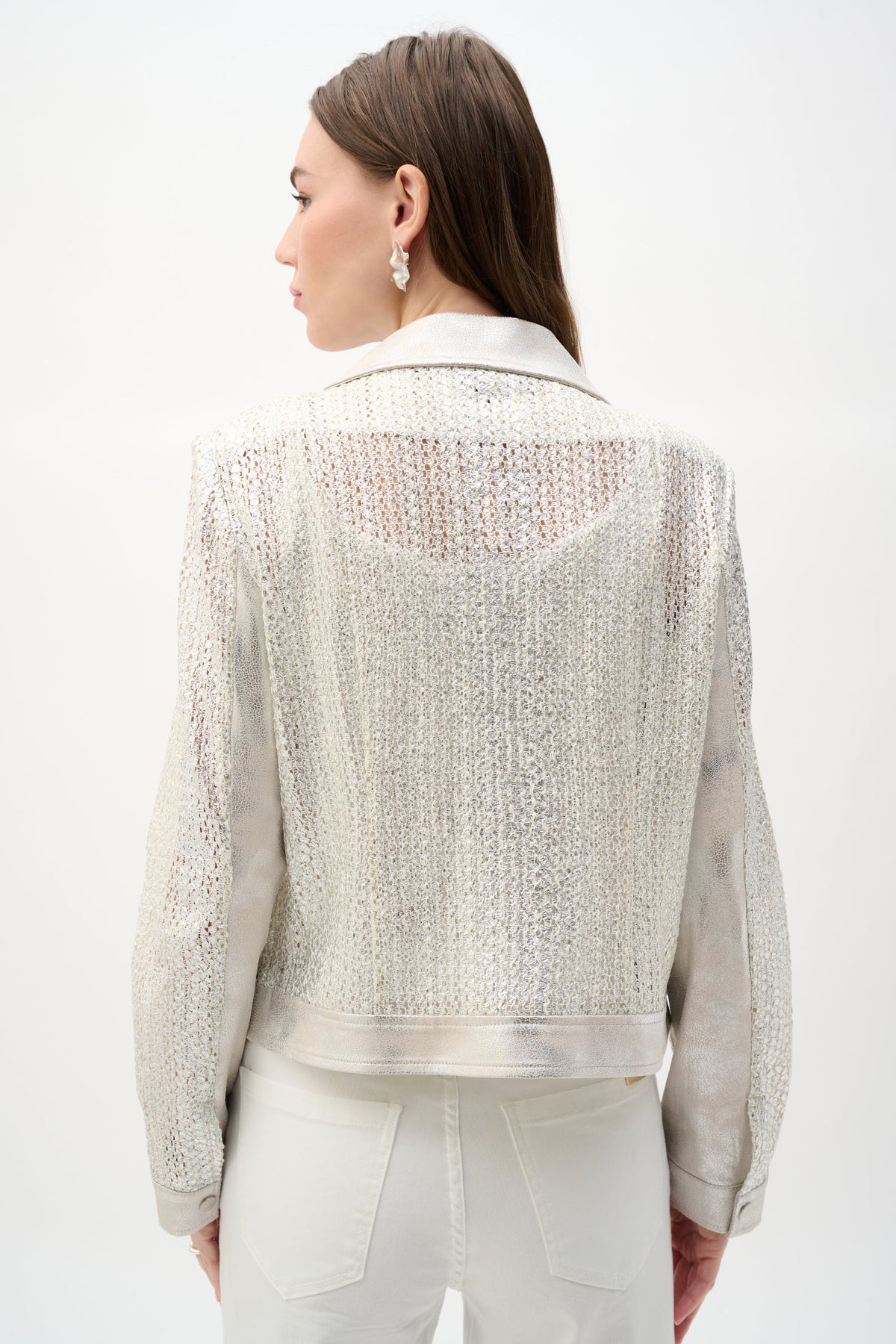 Back view of cropped silver metallic biker jacket with textured shimmer and long sleeves.