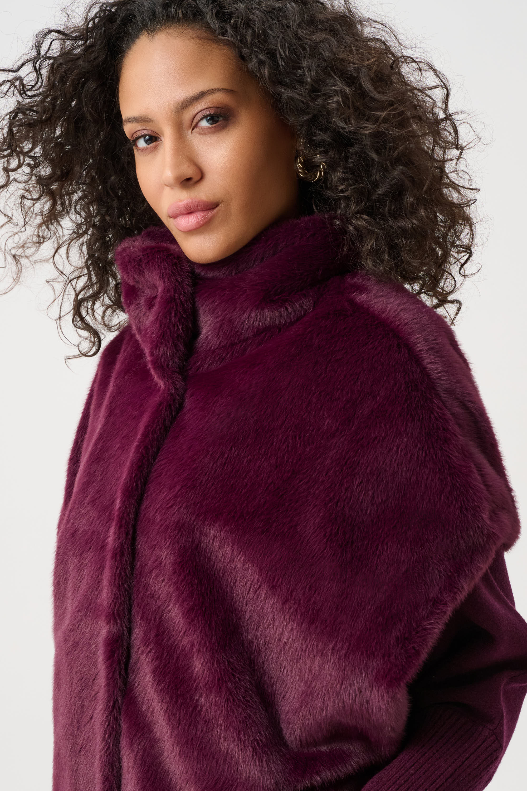 Close-up of burgundy faux fur funnel-neck vest texture and stitching Australia