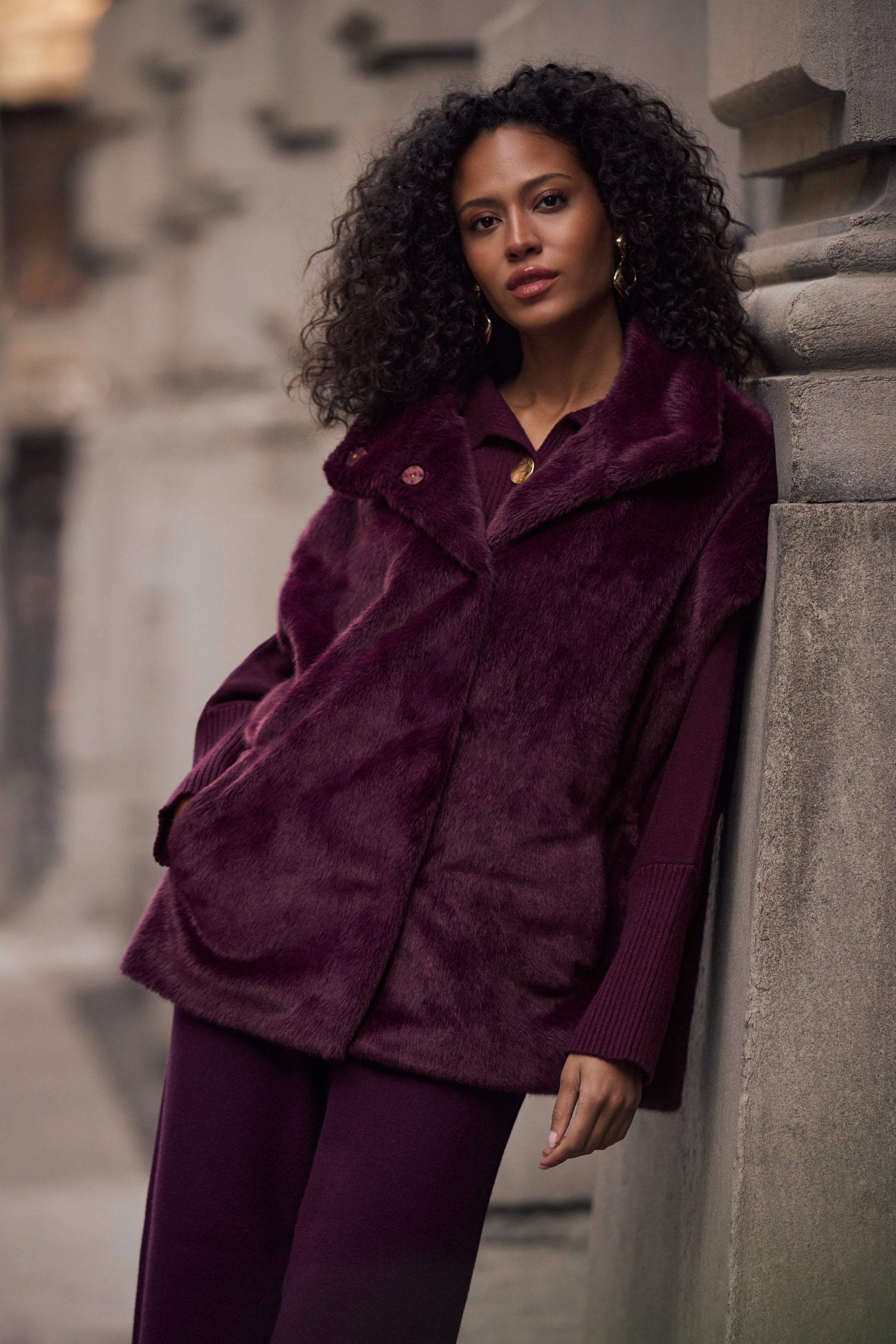 Woman wearing burgundy faux fur boxy vest styled with pants Australia