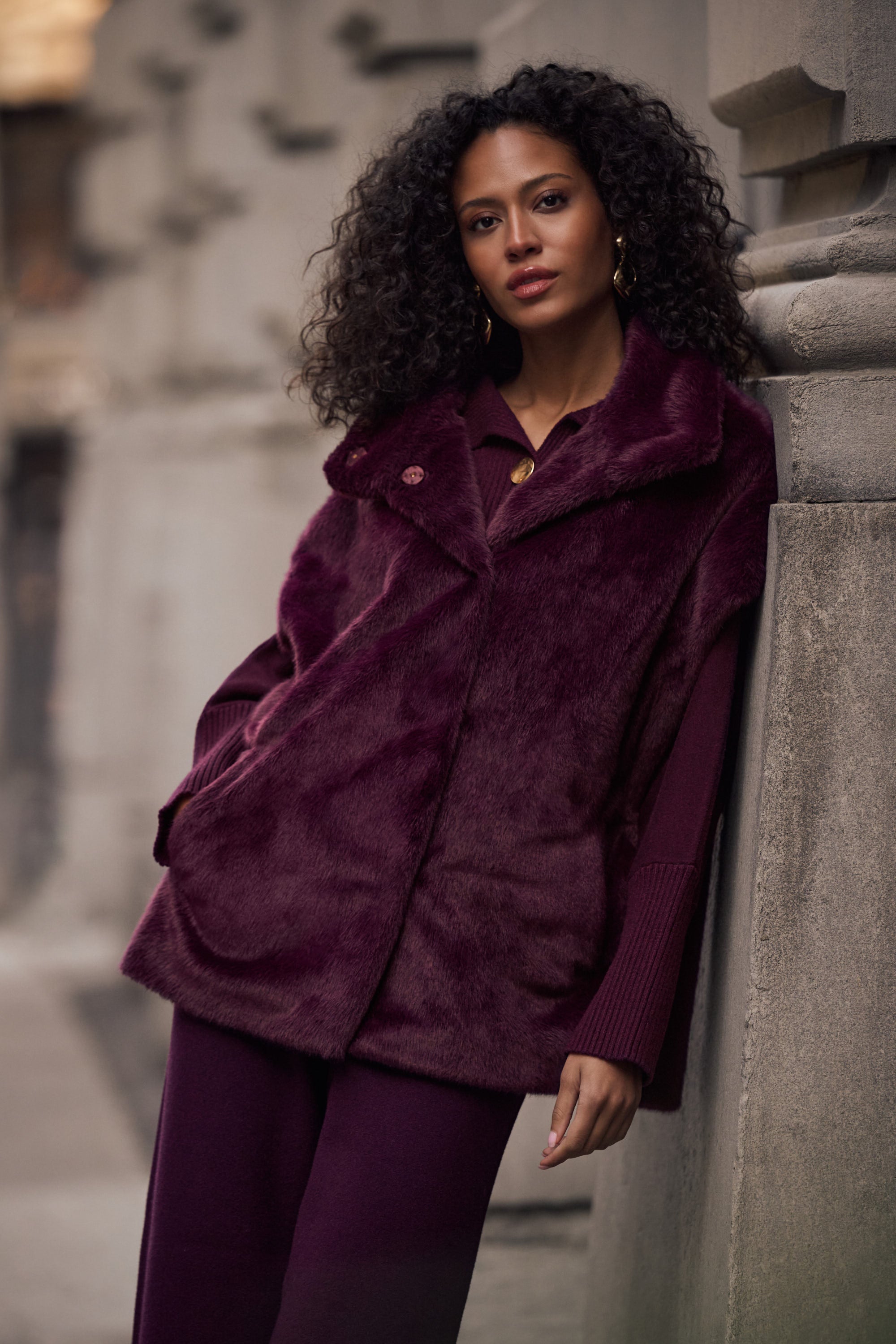 Woman wearing burgundy faux fur boxy vest styled with pants Australia