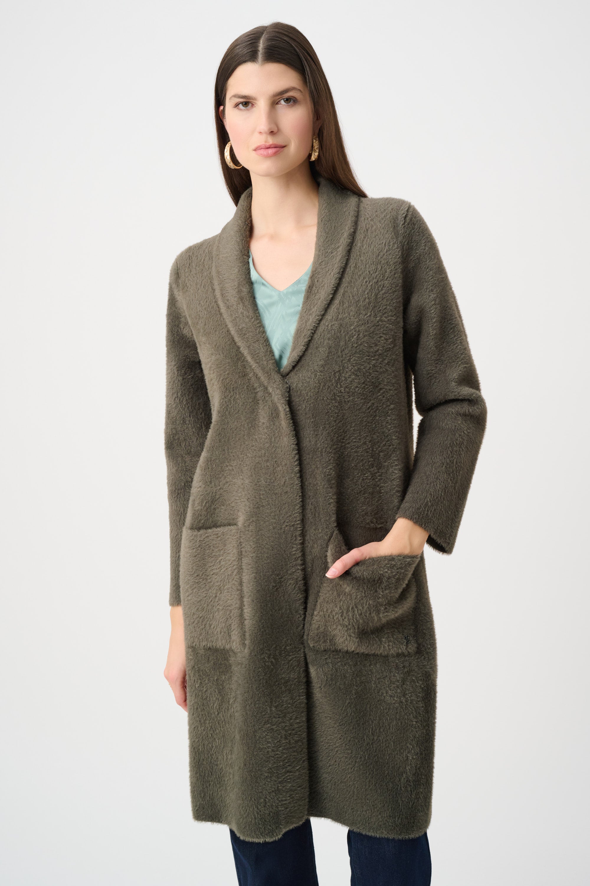 Model wearing beige coat with detachable fur collar on white background