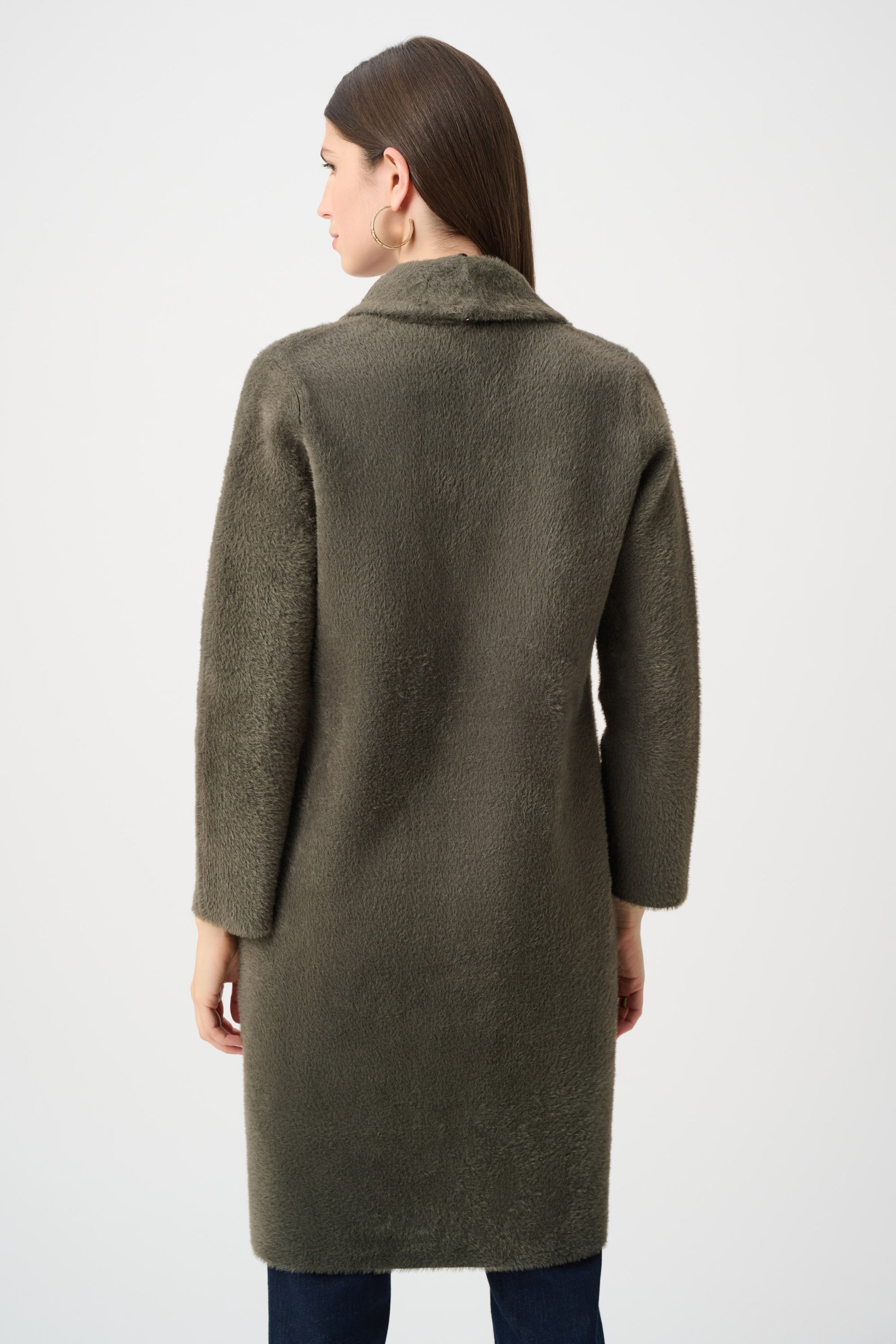 Close-up of beige cape-style coat with fur collar on white background