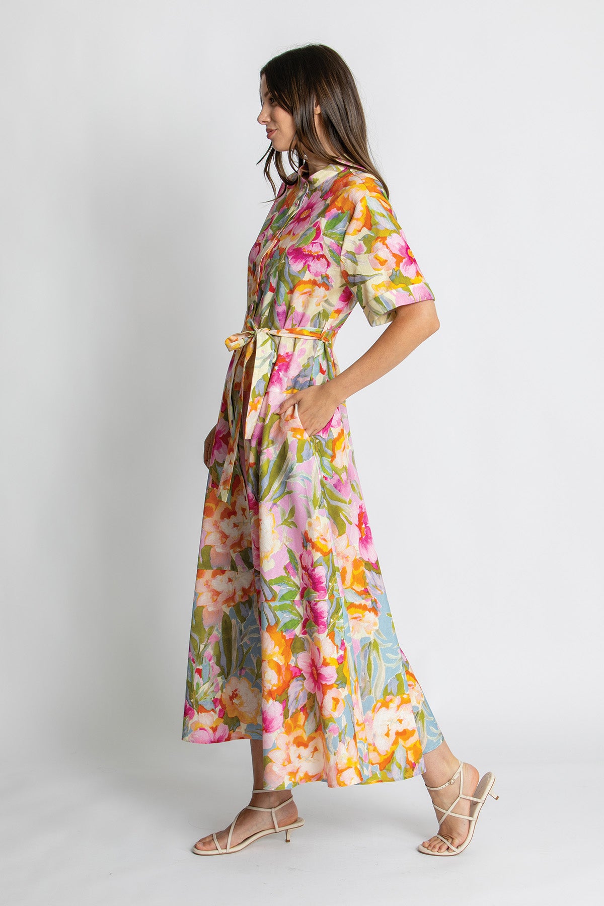 Side view of colourful floral belted midi dress.