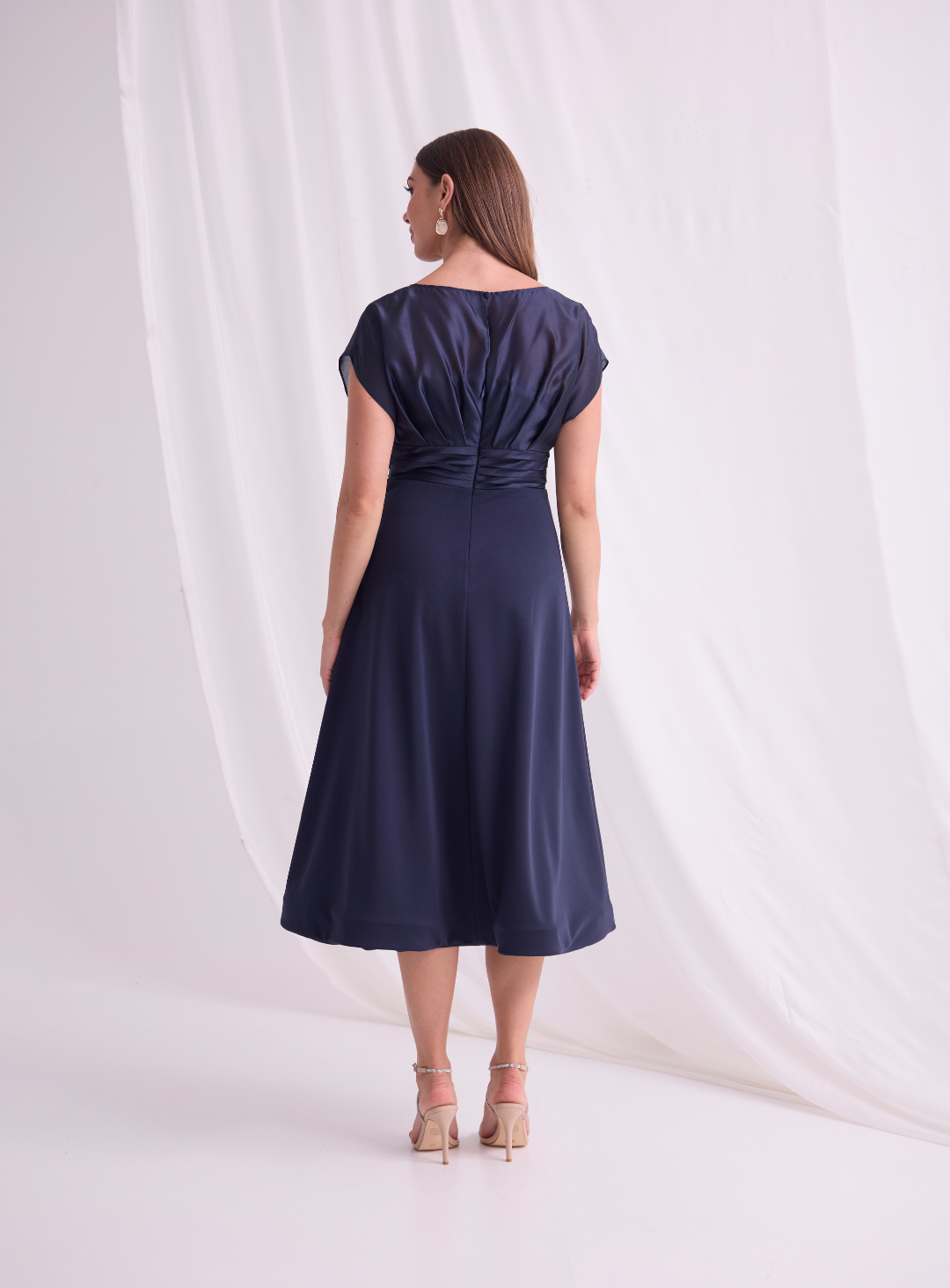 Back view of navy pleated waist midi dress.