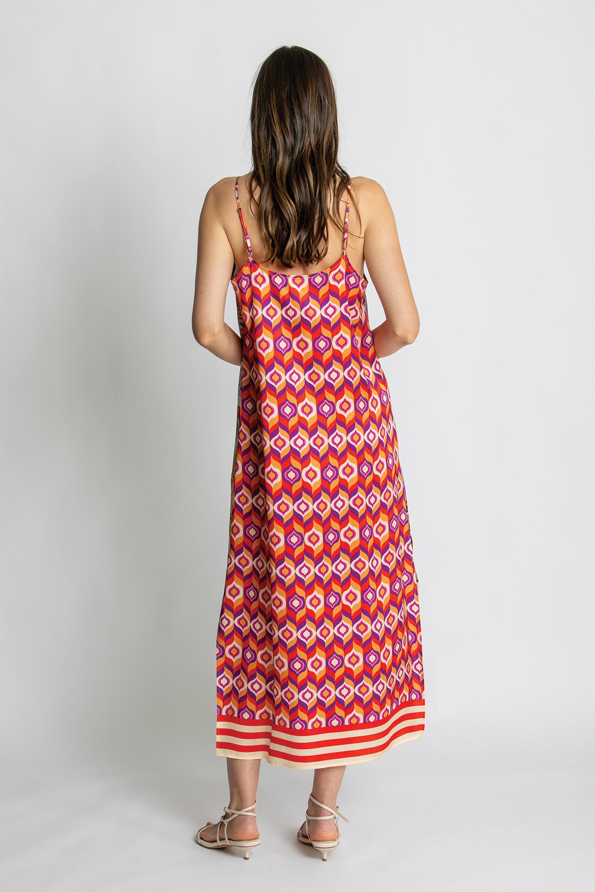 Back view of patterned strappy midi dress.