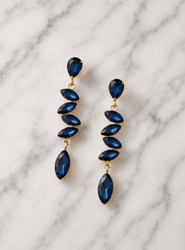 Showies Boutique midnight blue crystal teardrop statement earrings on marble background