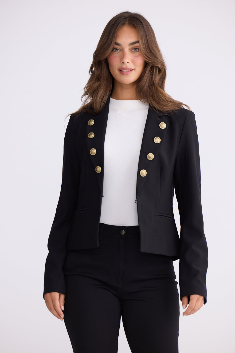Close detail of black blazer fabric and gold statement buttons design