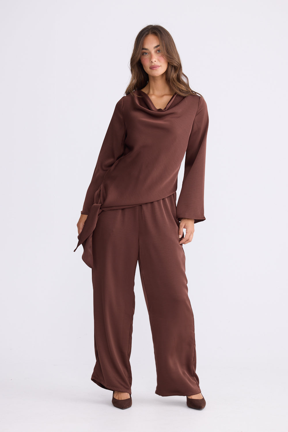 Side view of chocolate asymmetric drape top with flowy hem and relaxed silhouette