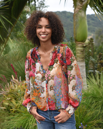 Multicolour floral long sleeve shirt with botanical print in tropical garden.