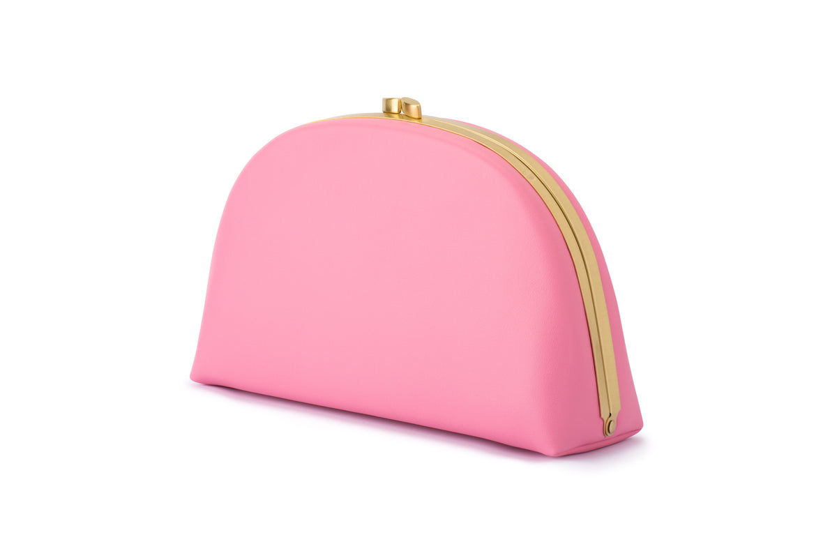 Pink half-moon clutch bag with gold frame.