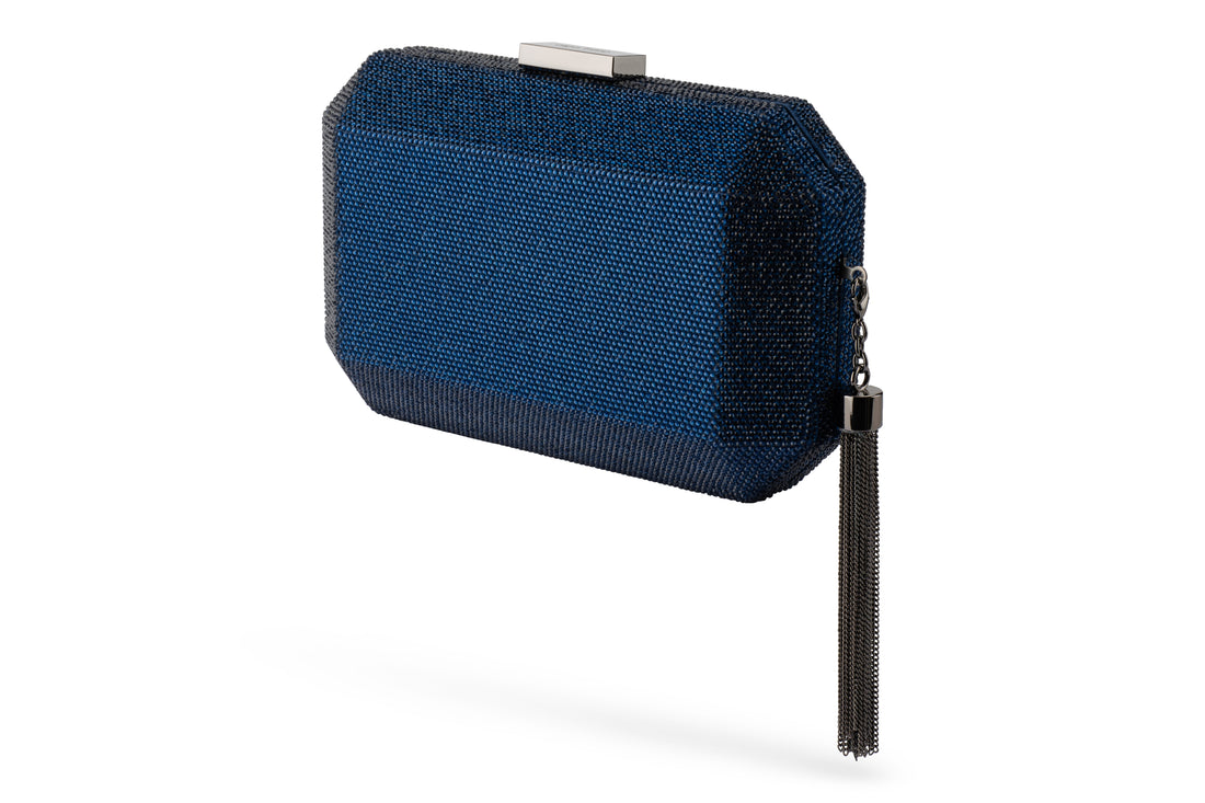 Navy blue textured clutch bag with tassel detail.