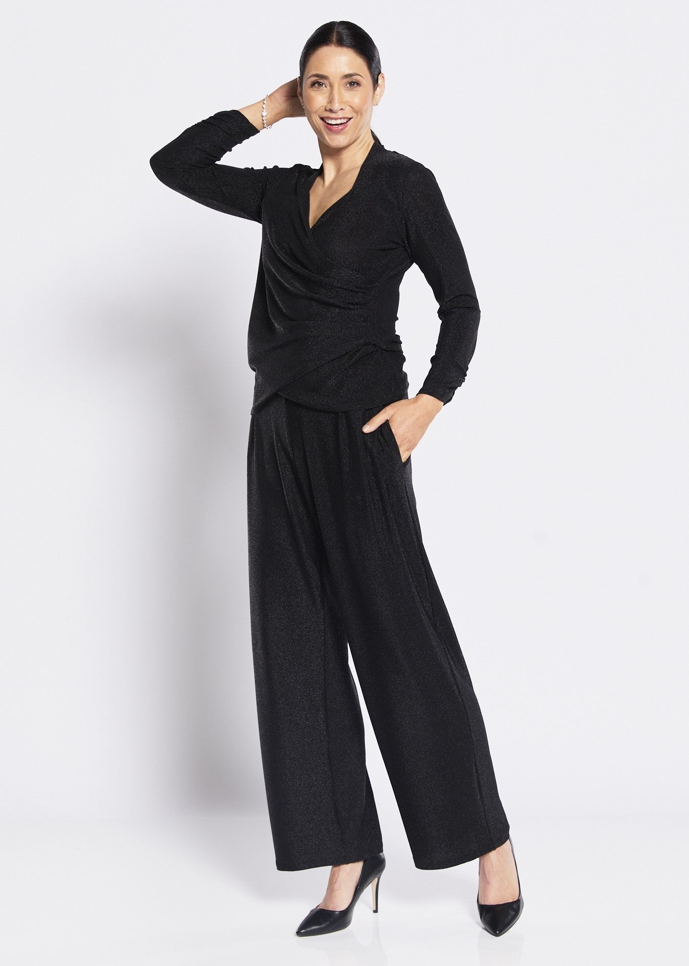 Black shimmer wide leg pants outfit for women on white background.