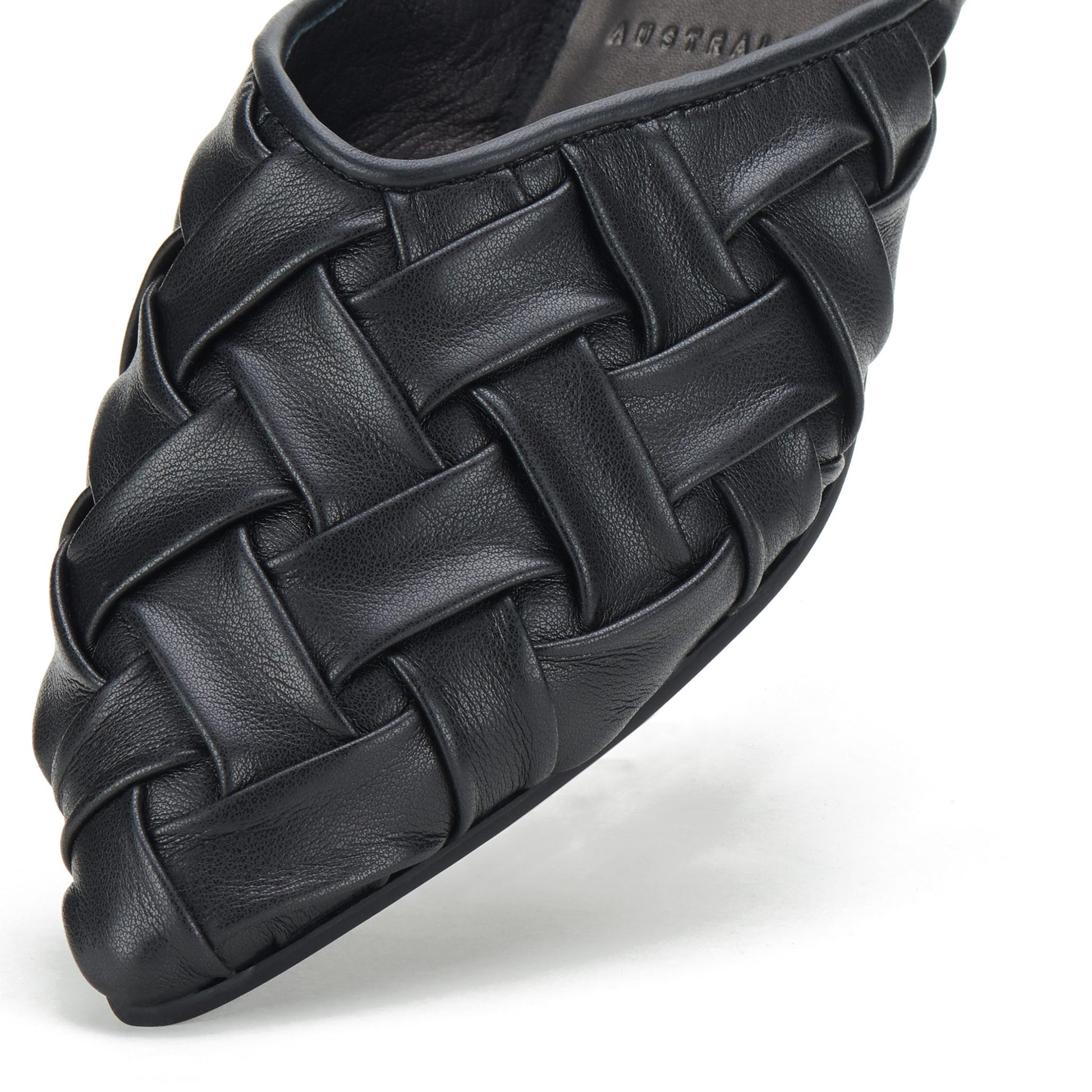Close-up of black woven leather pointed mule