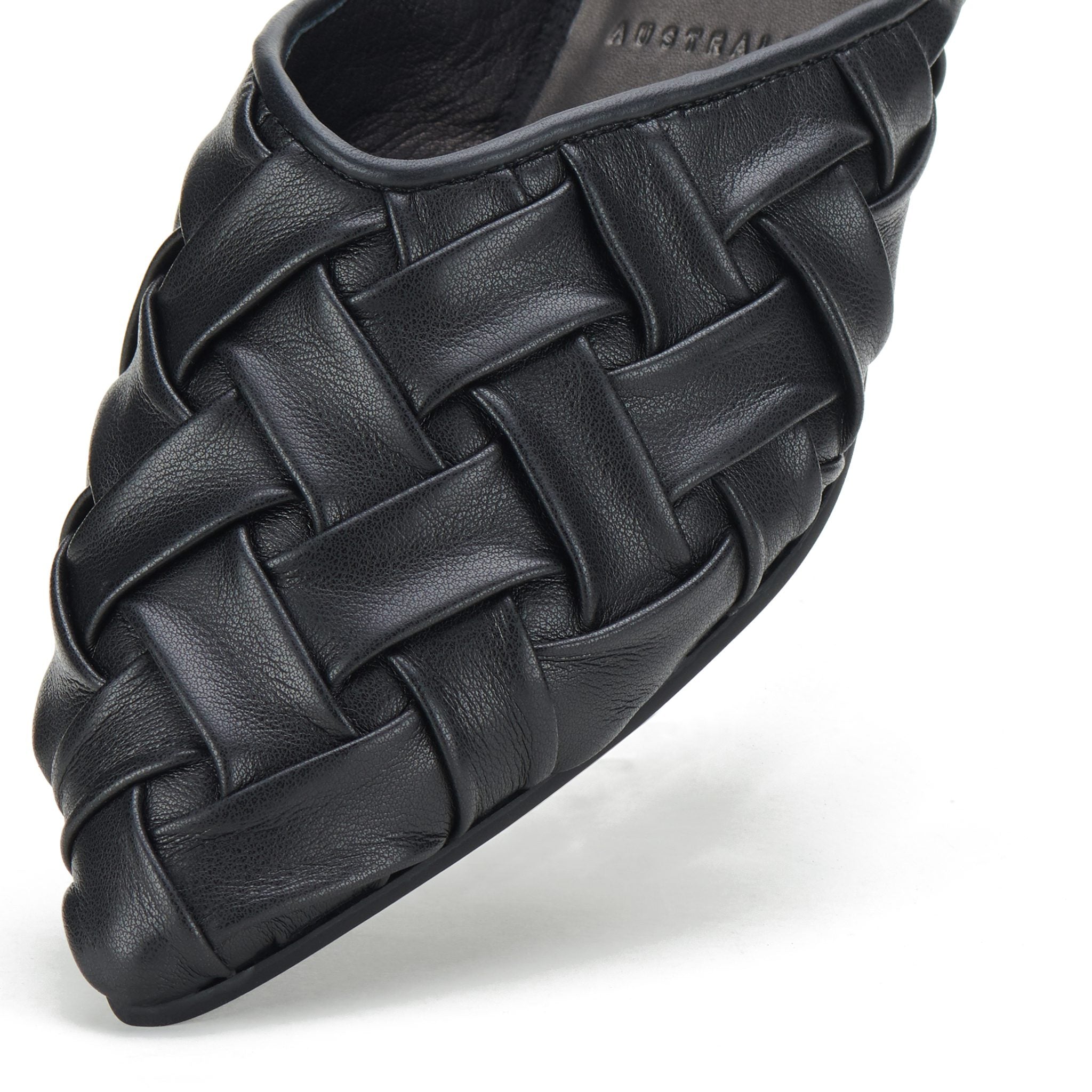 Close-up of black woven leather pointed mule