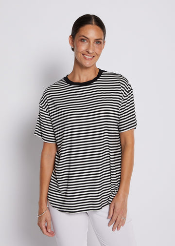 Black and white striped relaxed top with short sleeves, round neckline, and curved hem styled for casual everyday wear.