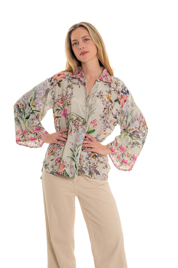Beige floral button-up blouse with long sleeves and botanical print.