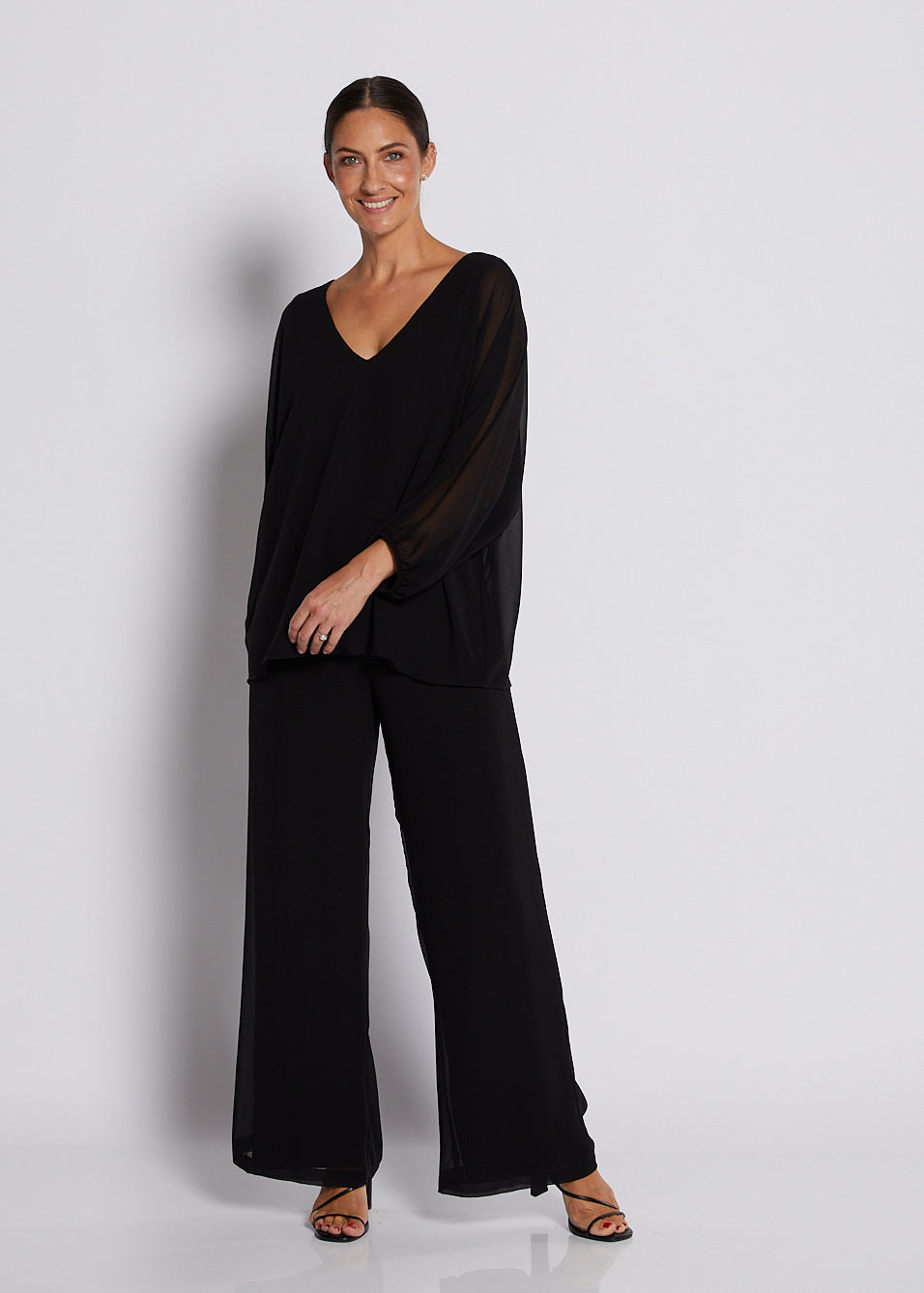 Black chiffon V-neck top with sheer batwing sleeves and wide-leg pants.