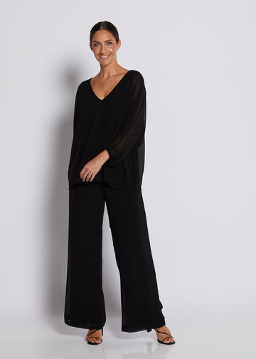 Black chiffon V-neck top with sheer batwing sleeves and wide-leg pants.