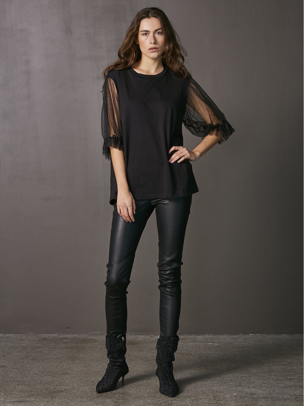The Vigga Tee is the perfect blend of elegance and versatility. The delicate mesh sleeves give it a chic edge, making it easy to dress up or down.