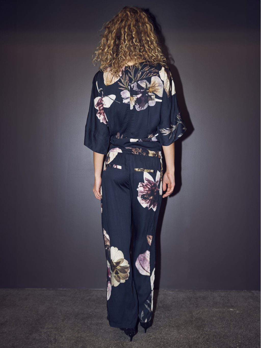 Back view of women’s floral sustainable trousers set
