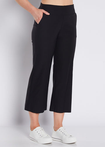 Black cropped wide leg pants with elastic waist and white sneakers front view