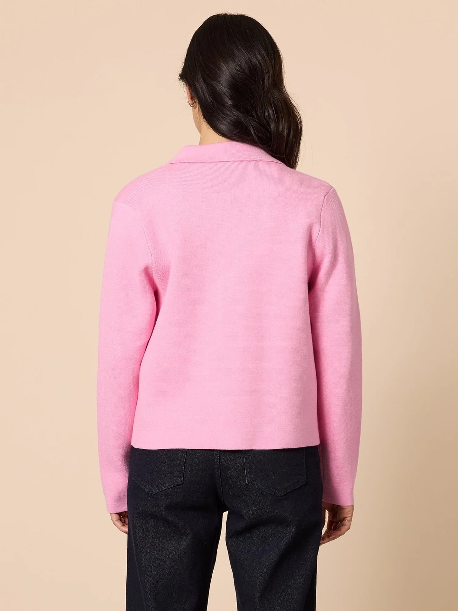 Back view of pink knit collar cardigan with structured fit and clean silhouette, paired with dark denim pants, from Showies Boutique Adelaide