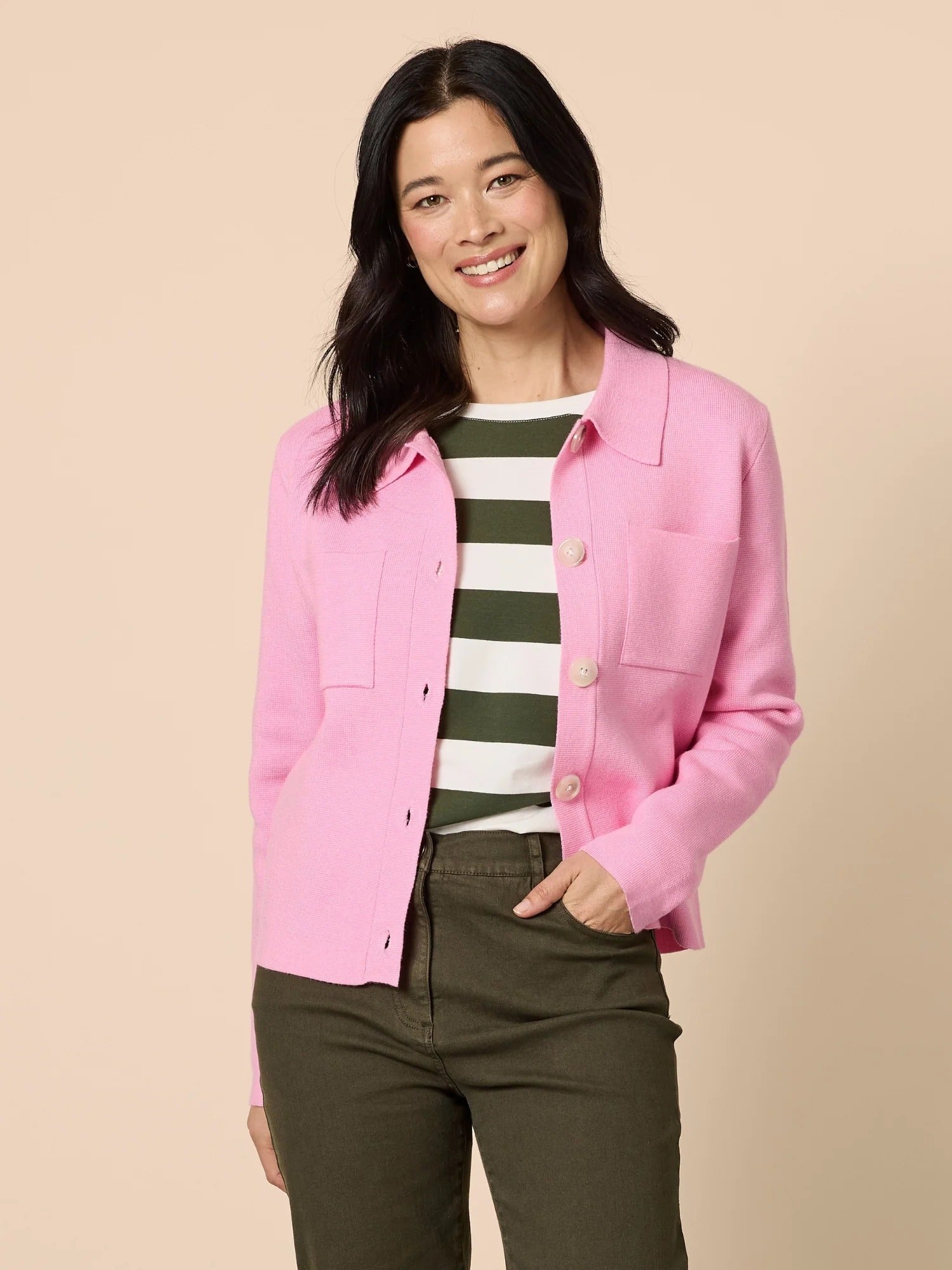 Woman wearing pink knit collar cardigan with button front and patch pockets, styled with striped top and olive pants, casual outfit from Showies Boutique Adelaide
